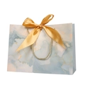 Elegant marble pattern paper gift bag with a golden silk bow and woven rope handle - XS (19x15x7cm) / Gilded Blue (Marble)