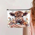 Detailed view of the Highland Cow and floral print on a white large makeup bag - Highland Cow with Red Flowers (jiayingpbb0114)