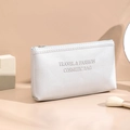 White PU leather cosmetic bag with embossed Travel & Fashion text and zipper closure - Silver - Small