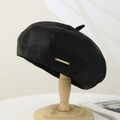 Close-up of black PU leather beret with HiCrown gold logo on wooden hat stand - PU Leather / Black