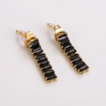 Detail of gold rectangular bar earrings with black square zircons on white background - Black Zirconia