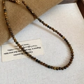 Macro shot of 4mm tiger eye bead necklace with golden lobster clasp and vintage style - 66# Coffee 4cm Necklace
