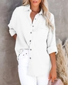 Detail of white cotton linen texture and button-up front on a long sleeve women's shirt - White