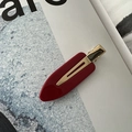 Detail of red acetate hair clip with gold metal alligator grip on minimalist background - No-Crease Hair Clips / Red