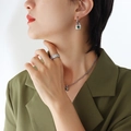 Silver chunky chain necklace and earrings set with green zircon lock charms on a model - Earrings-Green Zirconia / Steel