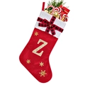 Close-up of red velvet Christmas stocking with gold letter Z and white knit cuff detail - Red Z