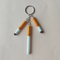 Miniature cigarette keychains with realistic filters and burnt ends on a pink background - 3 Simulation Cigarettes