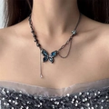Gothic butterfly pendant necklace in black finish with dark blue crystals on model - Blue Metal Butterfly Necklace