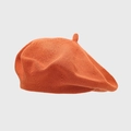 Detailed close-up of the knitted texture and top stem on the caramel orange beret - One Size / Orange Red