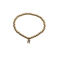 Detail of gold beaded bracelet featuring a colorful rhinestone letter R pendant charm - Letter R