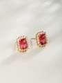 Close-up of golden geometric earrings featuring rectangular red gemstones and white crystals - Stud Earrings / 24K Gold Plated Ruby Red