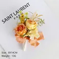 Elegant orange faux rose boutonniere with green leaves and a delicate pleated bow - Corsage / Orange
