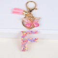 Pink resin alphabet F keychain with glitter flowers, butterfly charm and tassel - Letter F