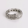 Detailed macro shot of a silver snake-shaped ring with pavé-set shimmering crystals - US 7 / Steel