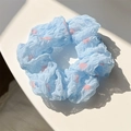 Light blue scrunchie with pink floral pattern made of wrinkled fabric on white background - Blue Polka Dot