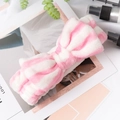 Detail of pink and white striped plush bow headband for skincare and makeup routines - Pink Stripe