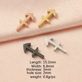 Detailed view of arrow pendants in rose gold, gold, black, and silver on pink satin fabric - Sagittarius
