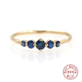 Detailed close-up of 925 sterling silver ring with five round blue gemstones and gold plating - US 6 / Blue Zirconia 5-Stone Row Gold Style (Style 7-Blue)