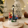 Close-up of resin Christmas miniatures with light-up lamp post, bear, and snowman - Elk Style