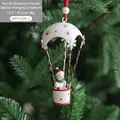 Iron snowman hot air balloon Christmas ornament with red star patterns on a tree - White Snowman