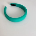 Detail view of a teal green padded headband with an authentic HAND MADE interior label - Emerald Green