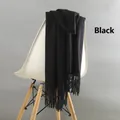 Thick black wool scarf with fringe trim draped over a chair for winter warmth - Tassel Style / 220g (200x70cm) / Black