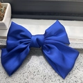 Detail of royal blue satin bow hair clip featuring soft silk texture and elegant sheen - Sapphire Blue