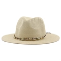 Close-up of straw fedora hat featuring woven texture and white shell beaded band detail - Beige