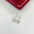 Simple freshwater pearl stud earrings on white leather background with red jewelry box - 8mm