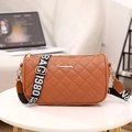 Brown quilted crossbody bag with BAG 1980 strap and Sunny logo on white table - Brown