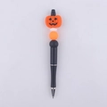 Close-up of a black beaded pen featuring a silicone Halloween pumpkin topper and beads - Smiling Pumpkin