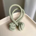 High-elastic light green ribbed hair tie with double knit balls on a ceramic plate - Light Green