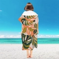 Adult hooded beach poncho towel with tropical leaf patterns on a white background - Pullover Style - Sunset Monstera