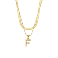 Detail of a double-layered gold necklace featuring a snake chain and a pearl F pendant - Letter F