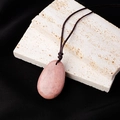 Natural teardrop crystal pendant in pink-brown with a woven cord on white stone - Rhodonite Teardrop Pendant