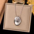 Minimalist silver-tone titanium steel necklace featuring an oval polished pendant design - H93 Oval Disc / Steel