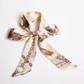 Beige silk scarf with golden chain and feather print tied in a bow style S47 - S47-Beige Feather Chain