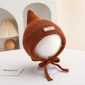Detail of caramel knit baby pixie hat with pointed top and decorative miu tag - 6-18 Months / Caramel color