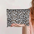 Close-up of leopard print canvas makeup bag with silver zipper held by a model - Classic Black White Brown Leopard Style (jiayingpbb0147)