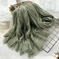 Green pleated oversized scarf with fringe edges displayed on a stylish wire rack - Army Green