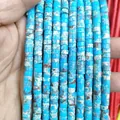 Detail view of 3x6mm flat cylindrical tiger eye beads being held for DIY jewelry - Imperial Jasper 3