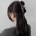 Detail view of large silver metal wave hair claw clip on model hair for women - Silver Rippled Streamline (FJ0835)