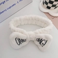 Plush white headband with black OMG embroidery for washing face and skincare routine - White