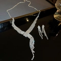 Elegant silver-toned necklace and earring set with shimmering cubic zirconia tassels - Y-Shape Tassel Necklace Set / Silver