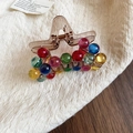 Macro detail of colorful acrylic beads on a translucent brown shark hair claw clip - Coffee Star Color Bead Style