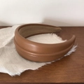 Detail of premium brown leather headband with visible stitching and soft inner lining - Brown