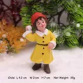 Winter snowman figurine wearing yellow coat and red hat for Christmas landscape decor - Child Snowball Fight Ornament
