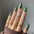 Glossy green almond-shaped press-on nails shown with elegant gold rings on hand - Green (JP2132)