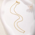 Detail of gold-plated flat link chain necklace with secure lobster clasp on tray - A0162 Flat Link Chain