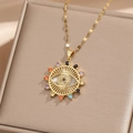 Detail of evil eye pendant with multicolored zircons on champagne satin background - Gold Colorful Zircon-Radiant Sun
